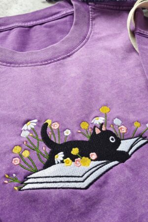 Cozy Cat on a Literary Adventure Embroidered T-shirt for Bookworms and Feline Enthusiasts