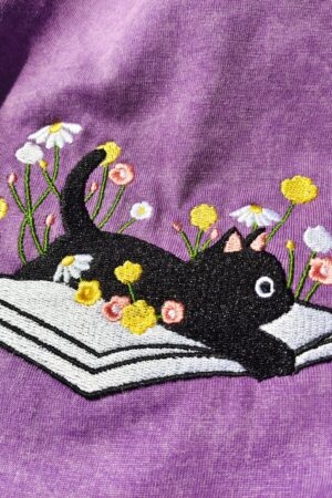 Cozy Cat on a Literary Adventure Embroidered T-shirt for Bookworms and Feline Enthusiasts