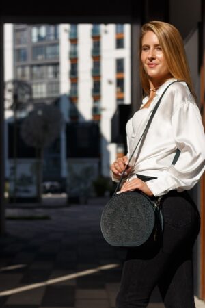 Exquisite Handmade Round Leather Bag with Intricate Flower Embossing