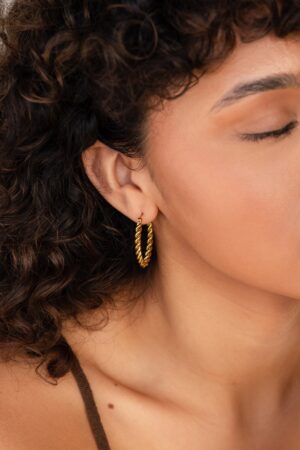 Bold and Twisted Elevate Your Style with Caitlyn's Minimalist Statement Hoops