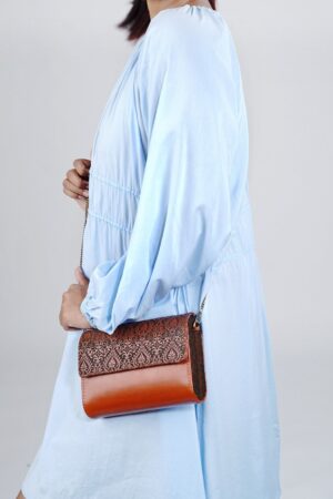 Exquisitely Crafted Orange Leather Sling Bag A Symphony of Teak Wood and Hand-Tooled Art