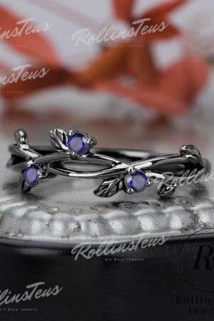 Nature's Embrace Blue Sapphire and Black Gold Twig Ring, a Symbol of Love and Growth